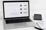 Calculator and laptop displaying TiltStack web design pricing tiers and cost factors